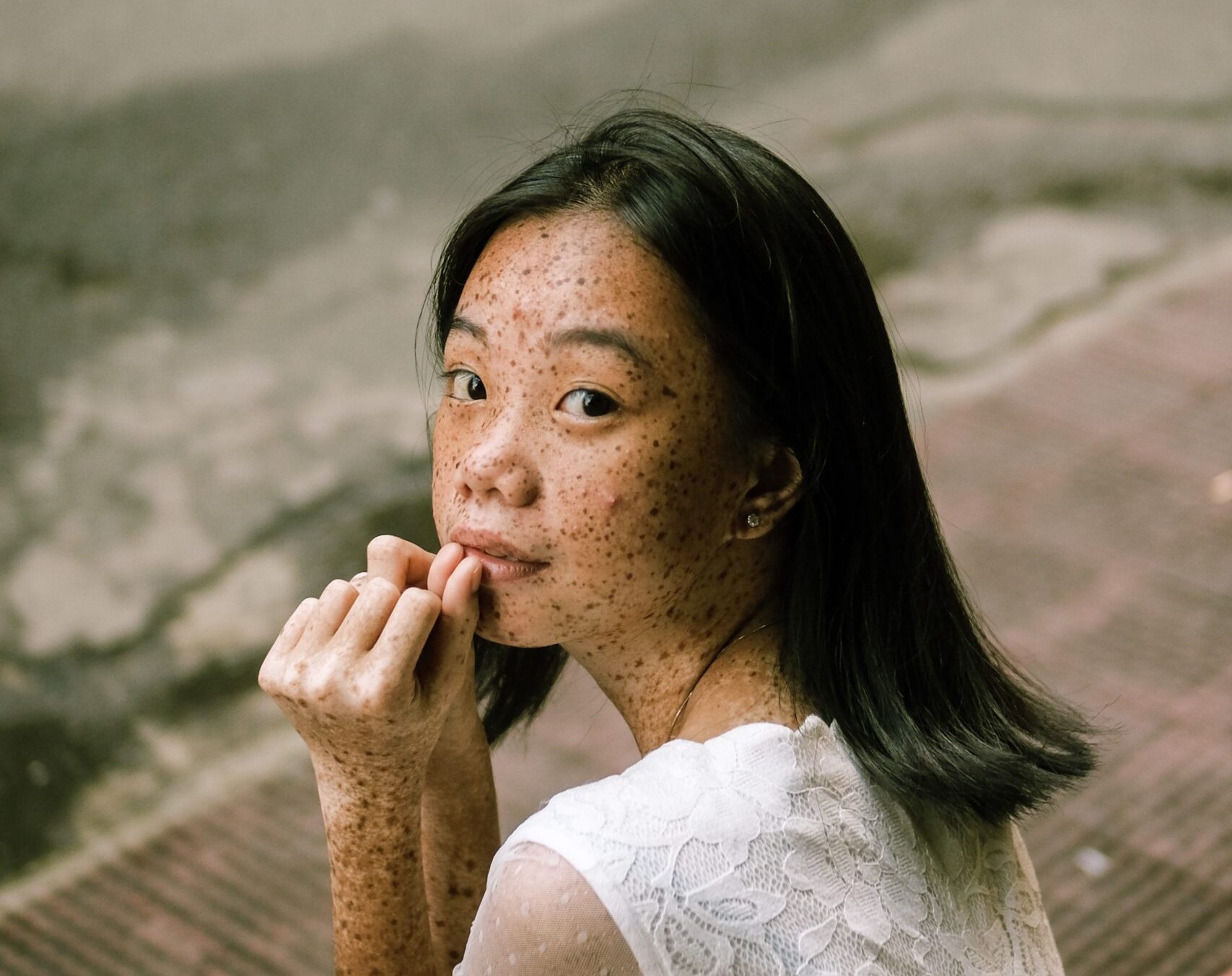 Woman Sits on Pavement